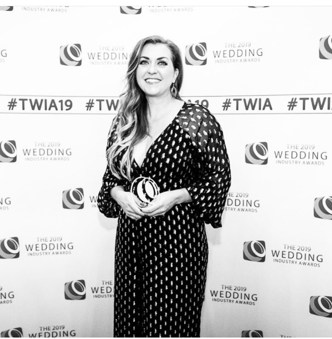 A BLACK AND WHITE IMAGES OF SOIRÉE STUDIO FOUNDER Corrie McDonald winning a TWIA wedding industry award.