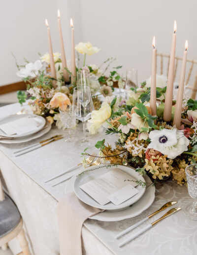 A colour image of a luxury wedding table with floristry designed by a luxury wedding planner