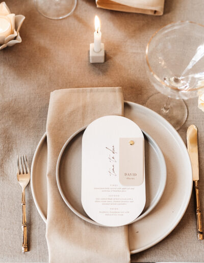 A luxury wedding place setting with wedding stationery