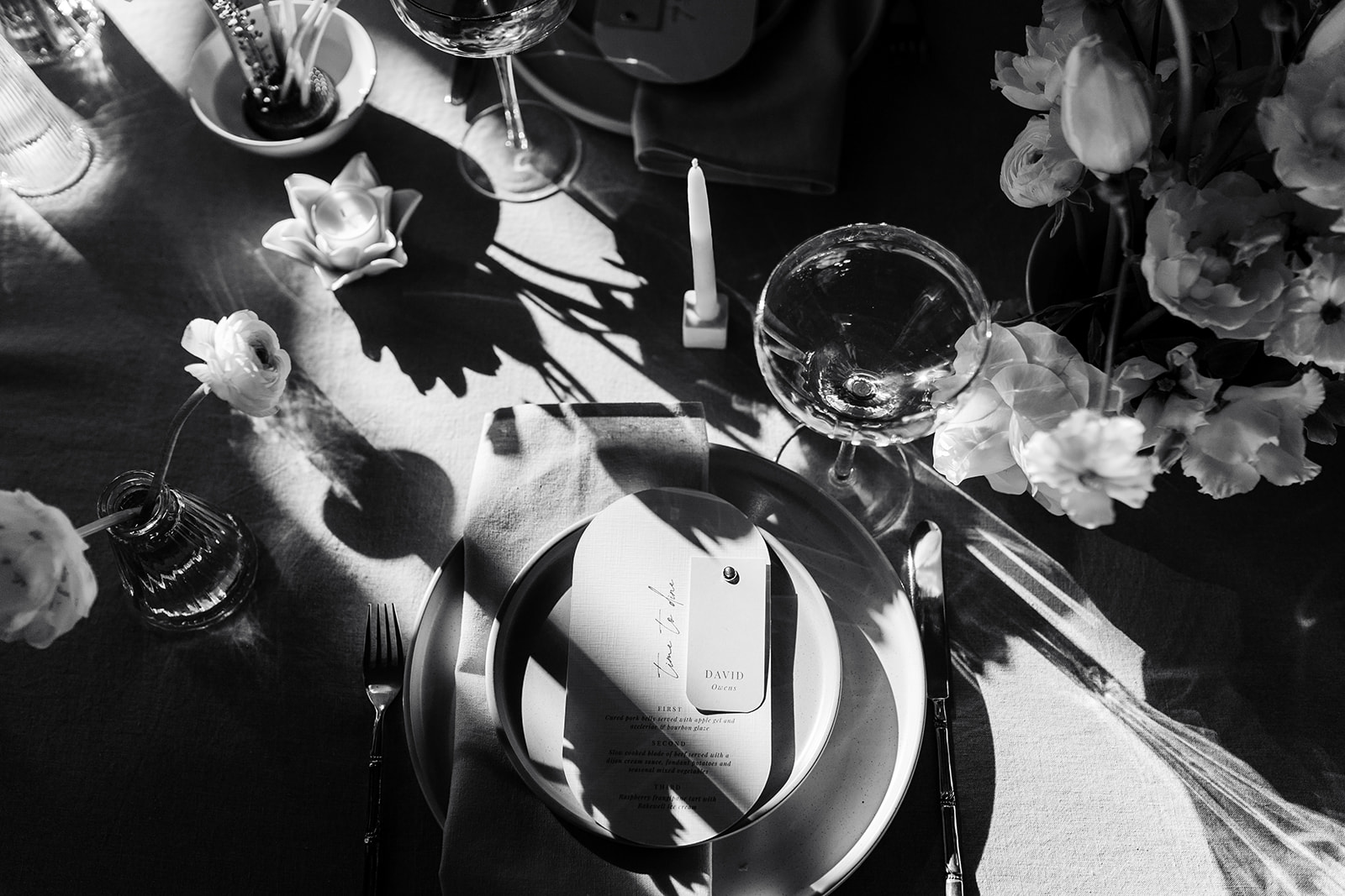 a black and white image of a wedding table with stationery planned by a wedding planner