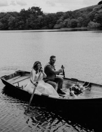 a black and white image of a bide and groom in a rowing boat