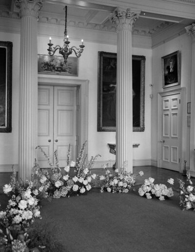 A black and white image of luxury wedding ceremony flowers designed by a luxury wedding planner