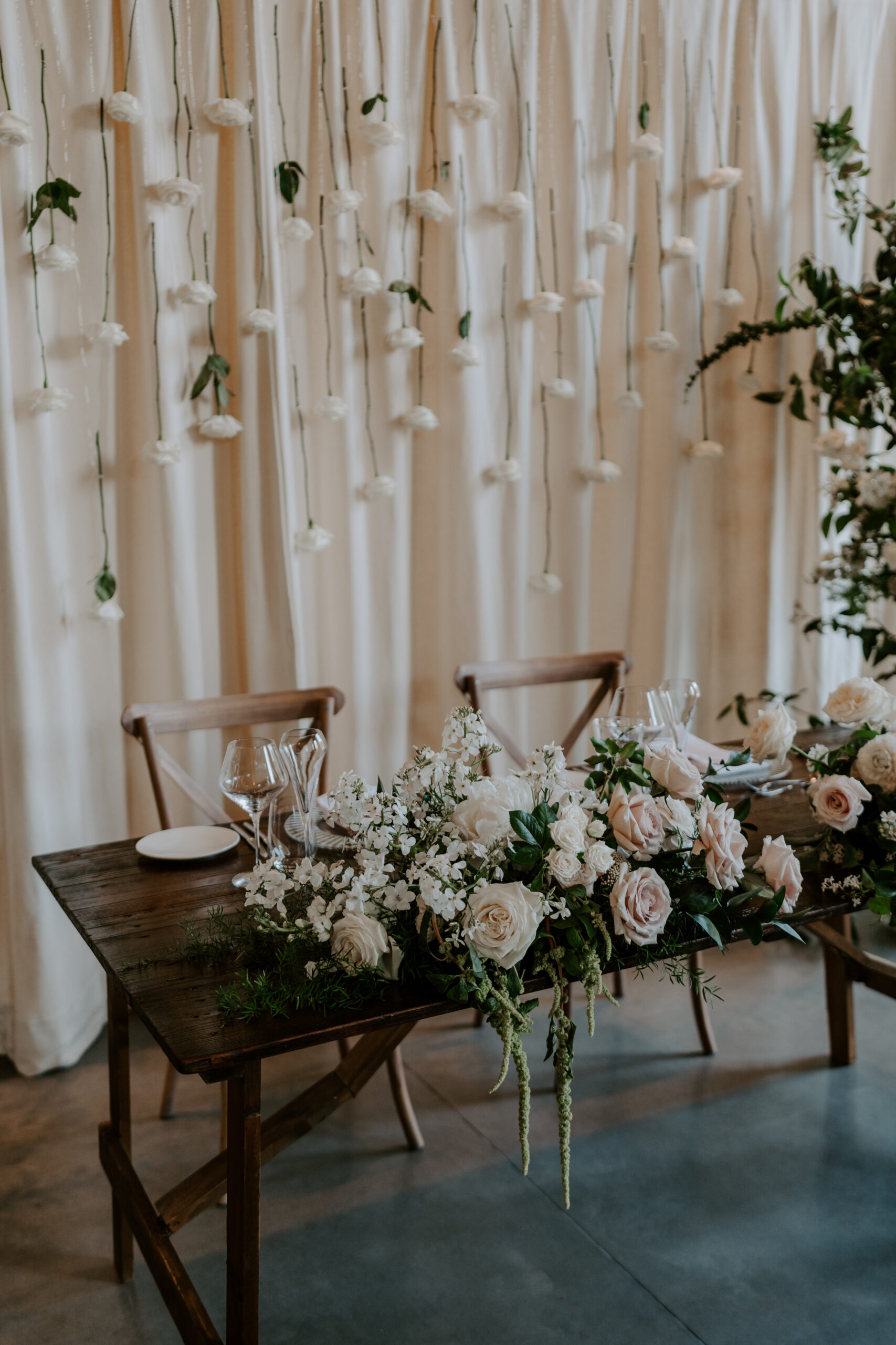 A table set up with white flowers and wedding styling.