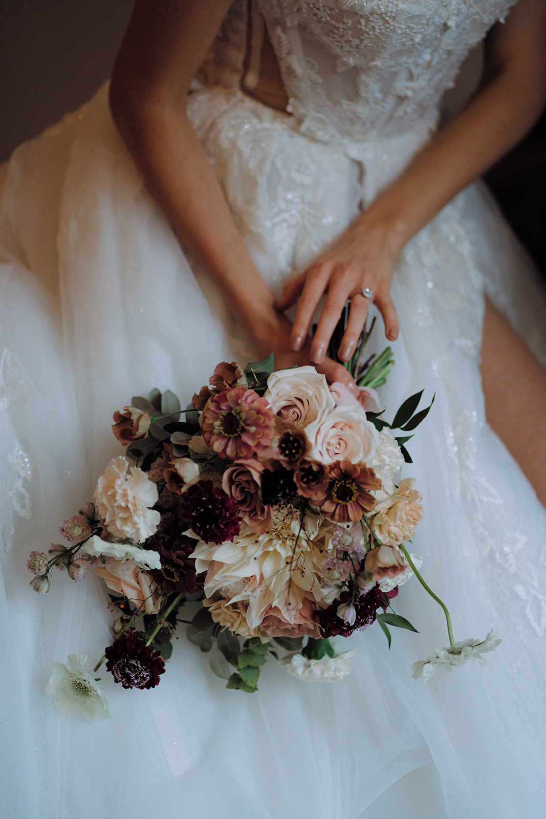 A colour photo showcasing long wedding tables styled with place settings and flowers, set in a hall.