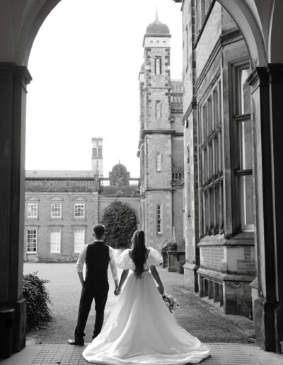 A black and white image of a bride and groom at Capesthorne Hall