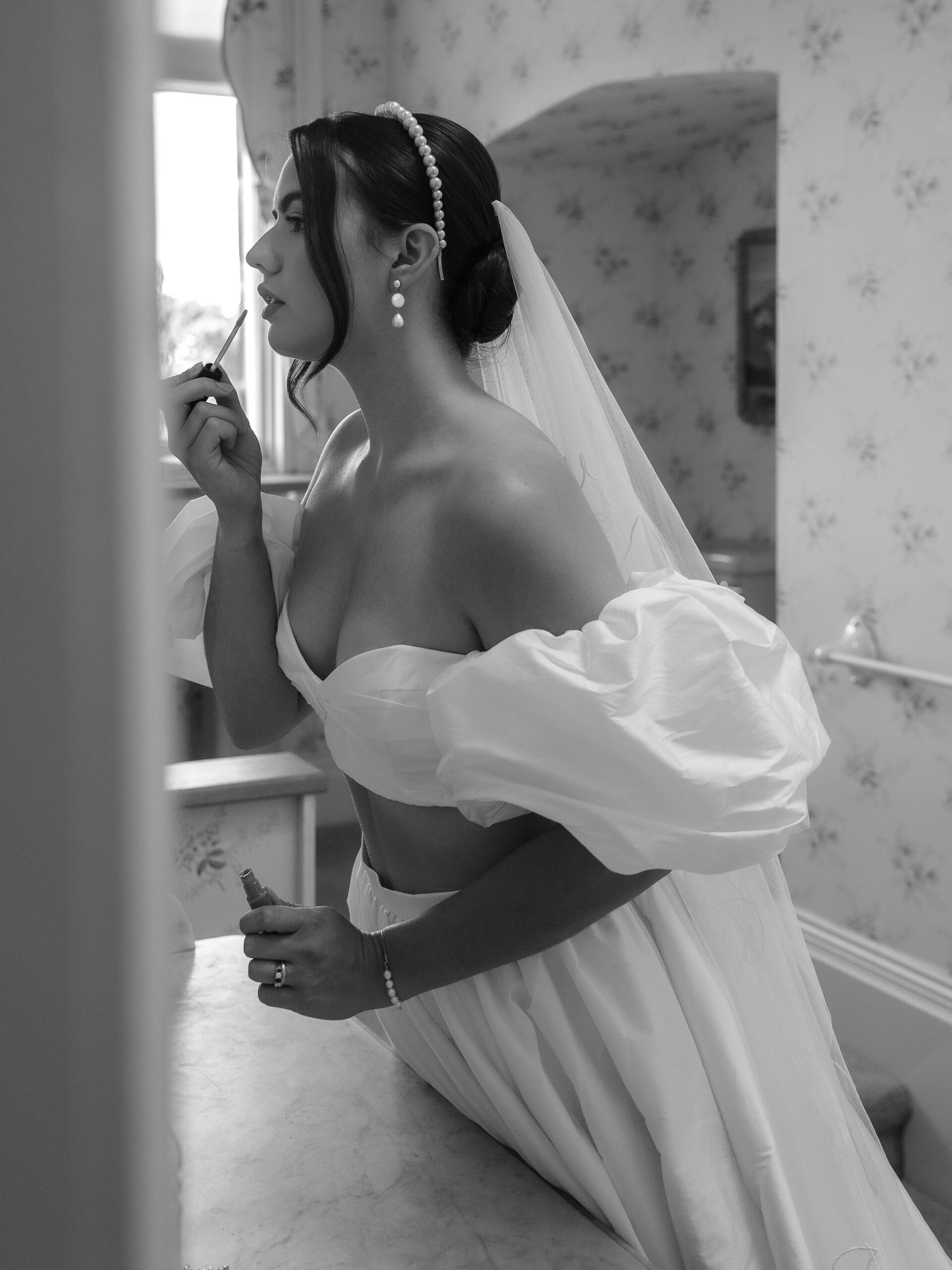 A black and white images of a bride at Capesthorne Hall in Cheshire