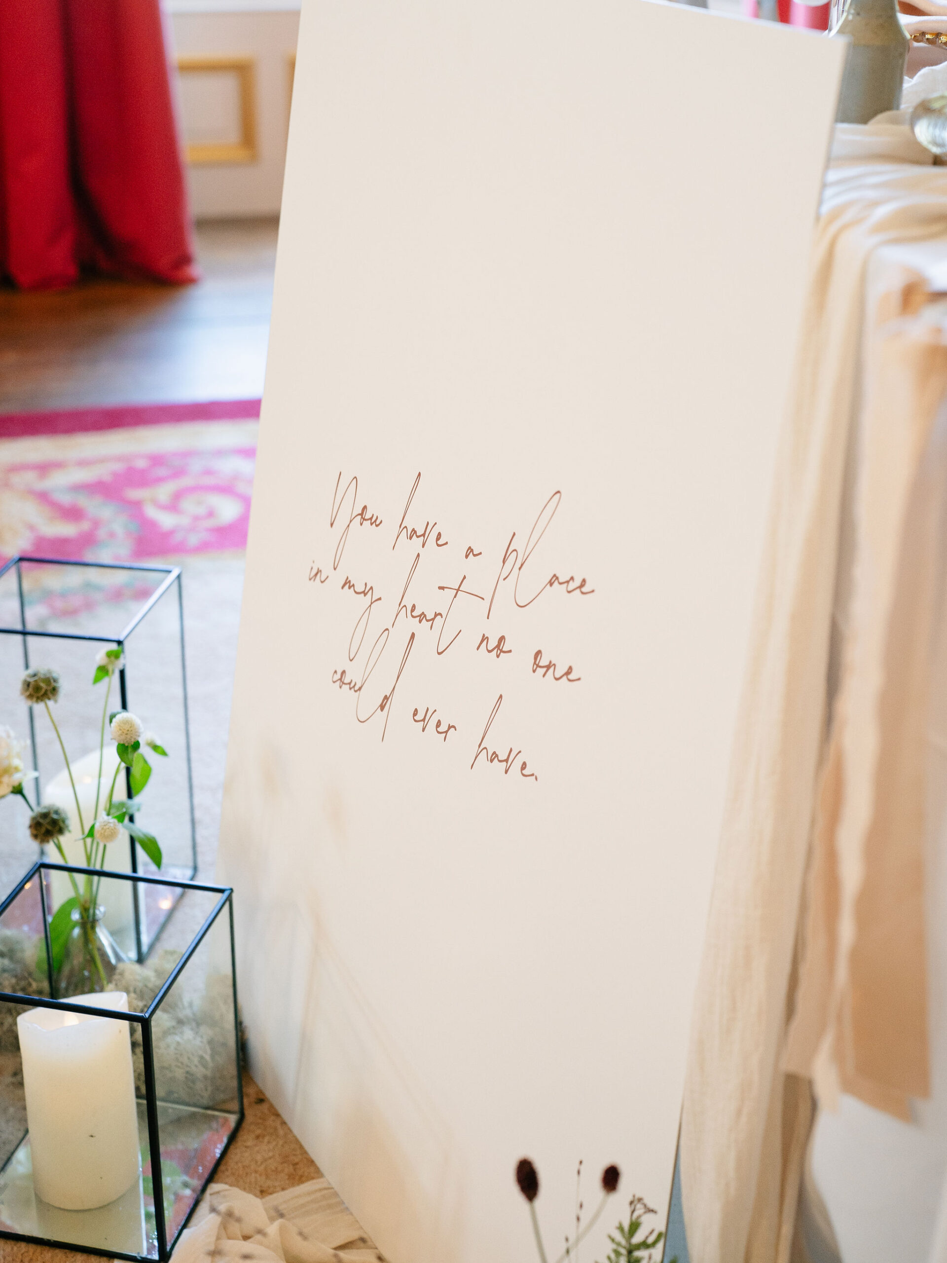 A colour images of a wedding table plan and welcome sign with flowers at Capesthorne Hall wedding venue in Cheshire.