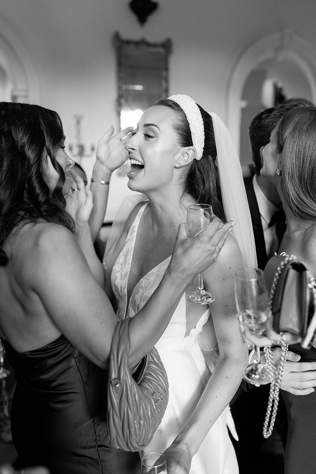 Madeleine & Chris A black and white image of a bride with her friends at Capesthorne Hall Cheshire.
