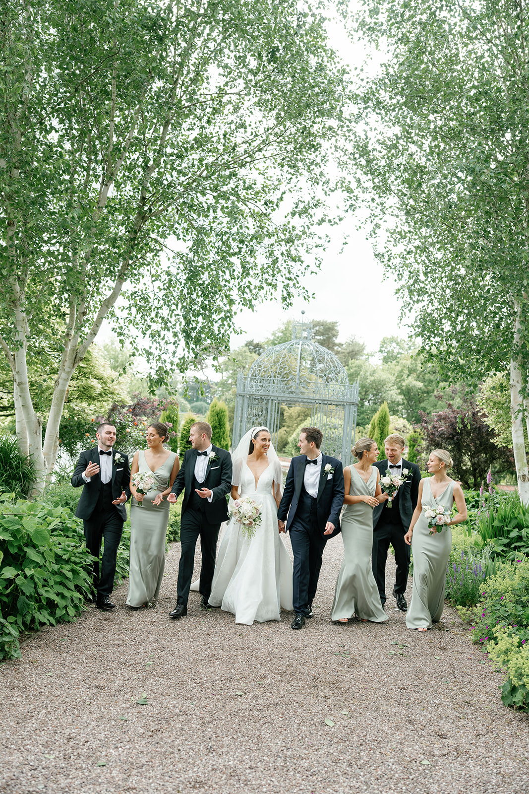 Madeleine & Chris A colour images of a bridal party with bridesmaids in sage dresses.