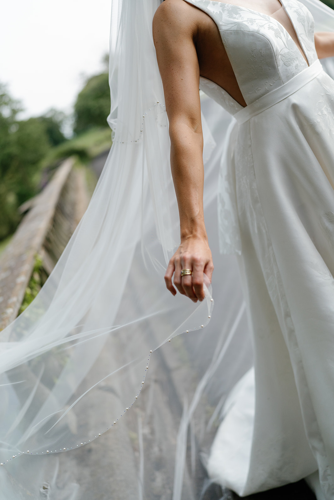 Madeleine & Chris A colour image of a bride in her dress with a beautiful decorative veil.