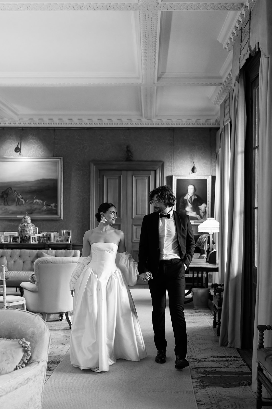 Birdsall House A bride and groom walking through the hallway at Birdsall House in Yorkshire after their wedding ceremony.