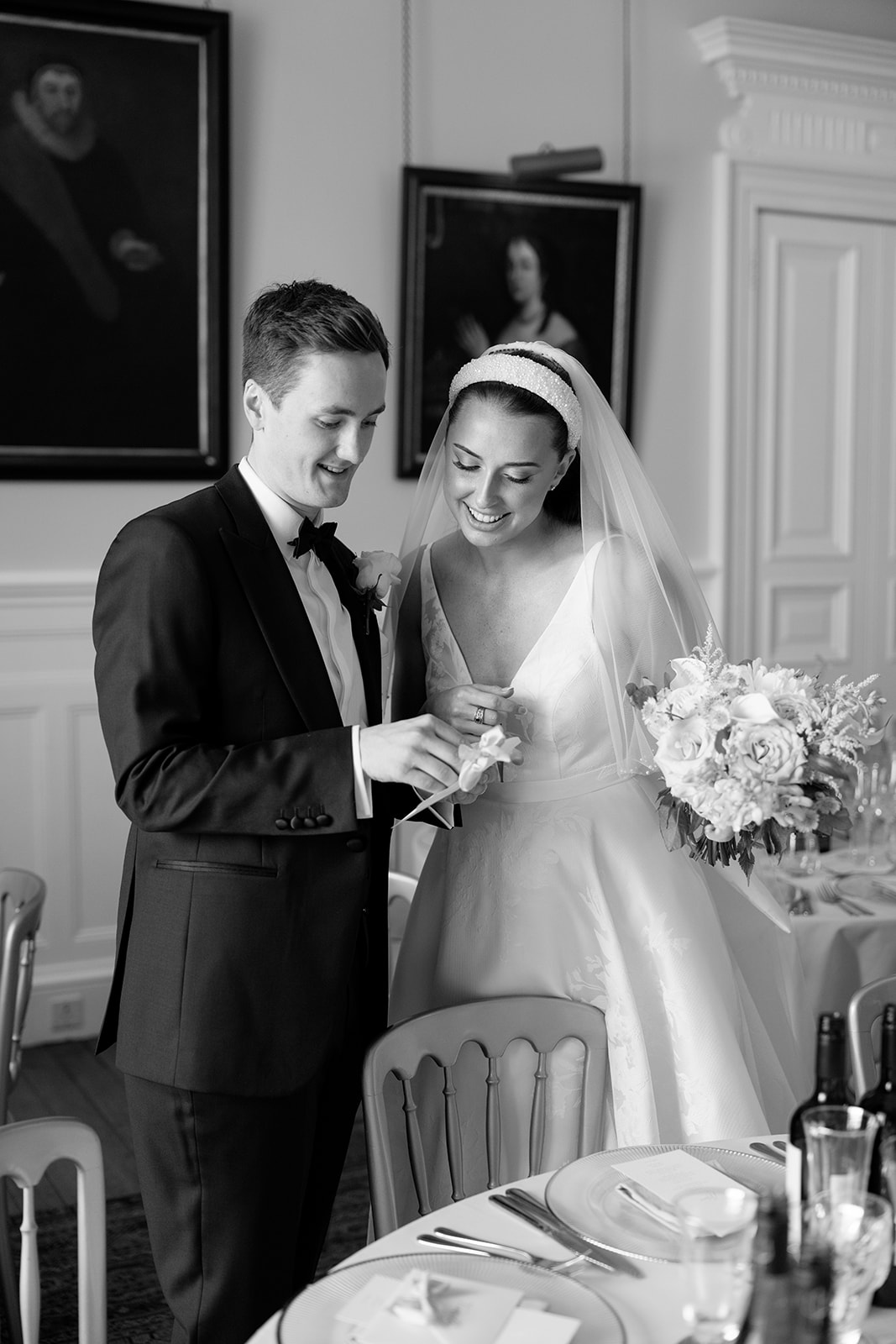 Madeleine & Chris A black and white image of a couple entering the Queen Ann suite at Capesthorne Hall in Cheshire.