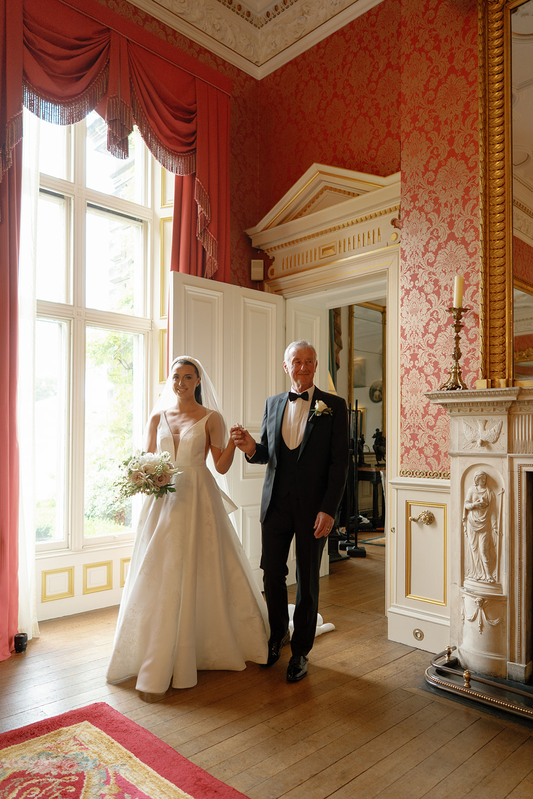 Madeleine & Chris A colour image of a bride entering her wedding ceremony at Capesthorne Hall in Cheshire, planned by Soiree Studio.
