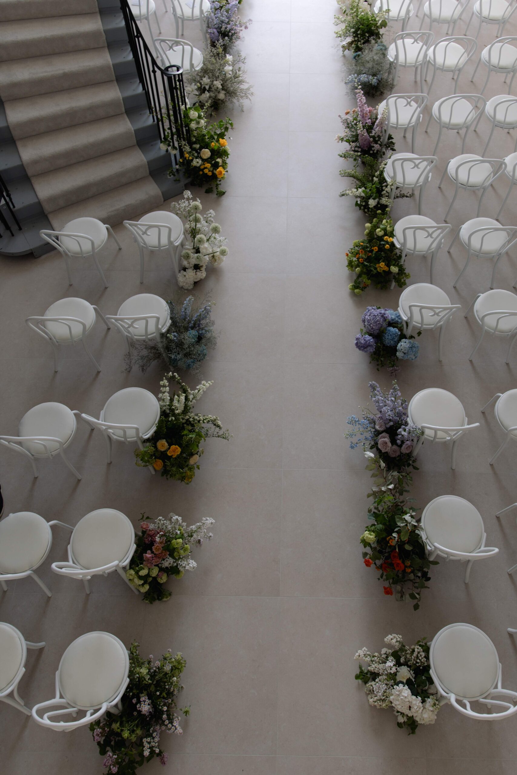 WEDDING-AISLE-DECOR-AND-FLORISTRY-CHESHIRE A colour image of a marquee wedding with long ceremony aisle and spring flowers down the aisle.