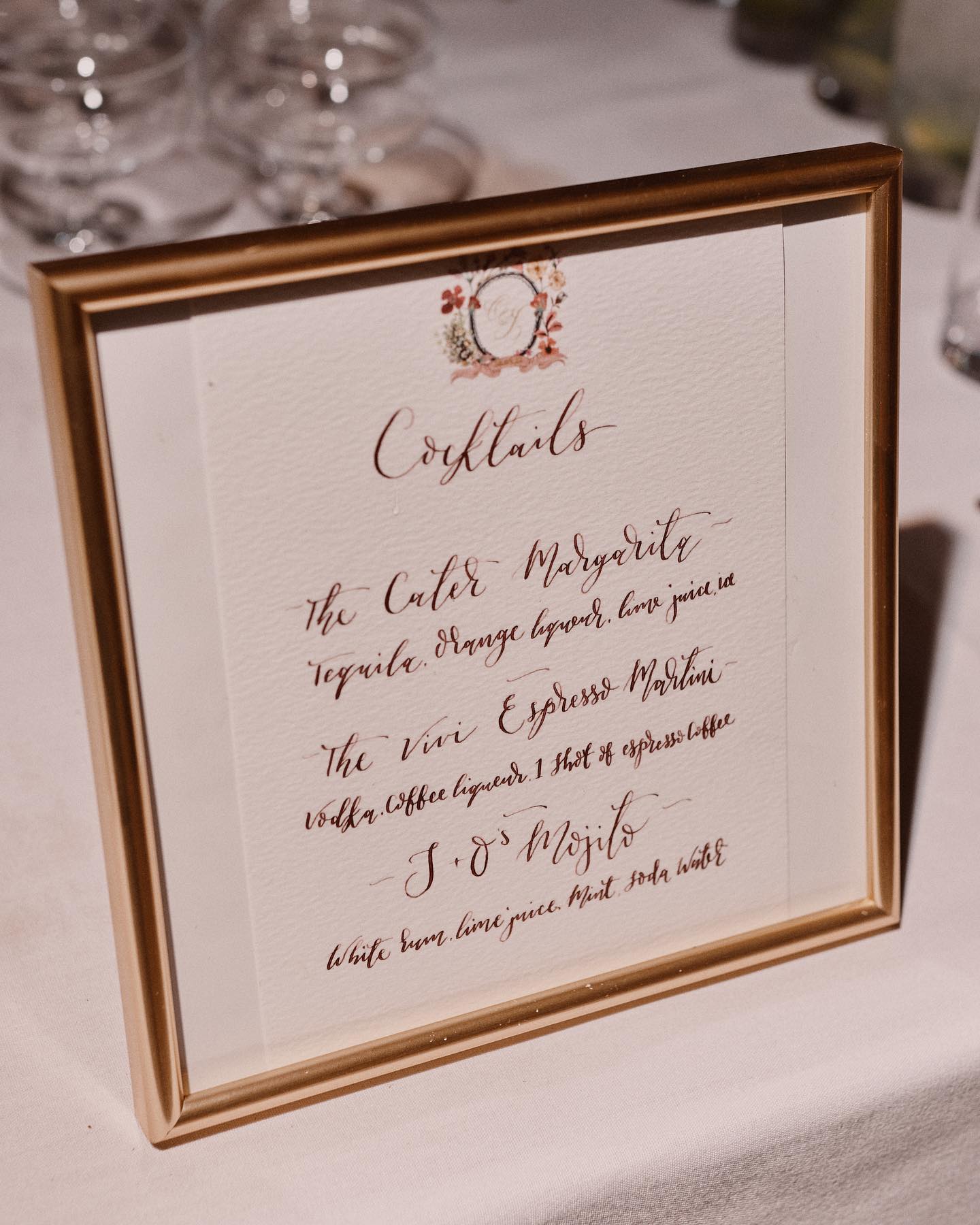 A colour image of beautiful wedding stationery in a calligraphy style cocktail menu at Hampton Manor by Soiree Studio.