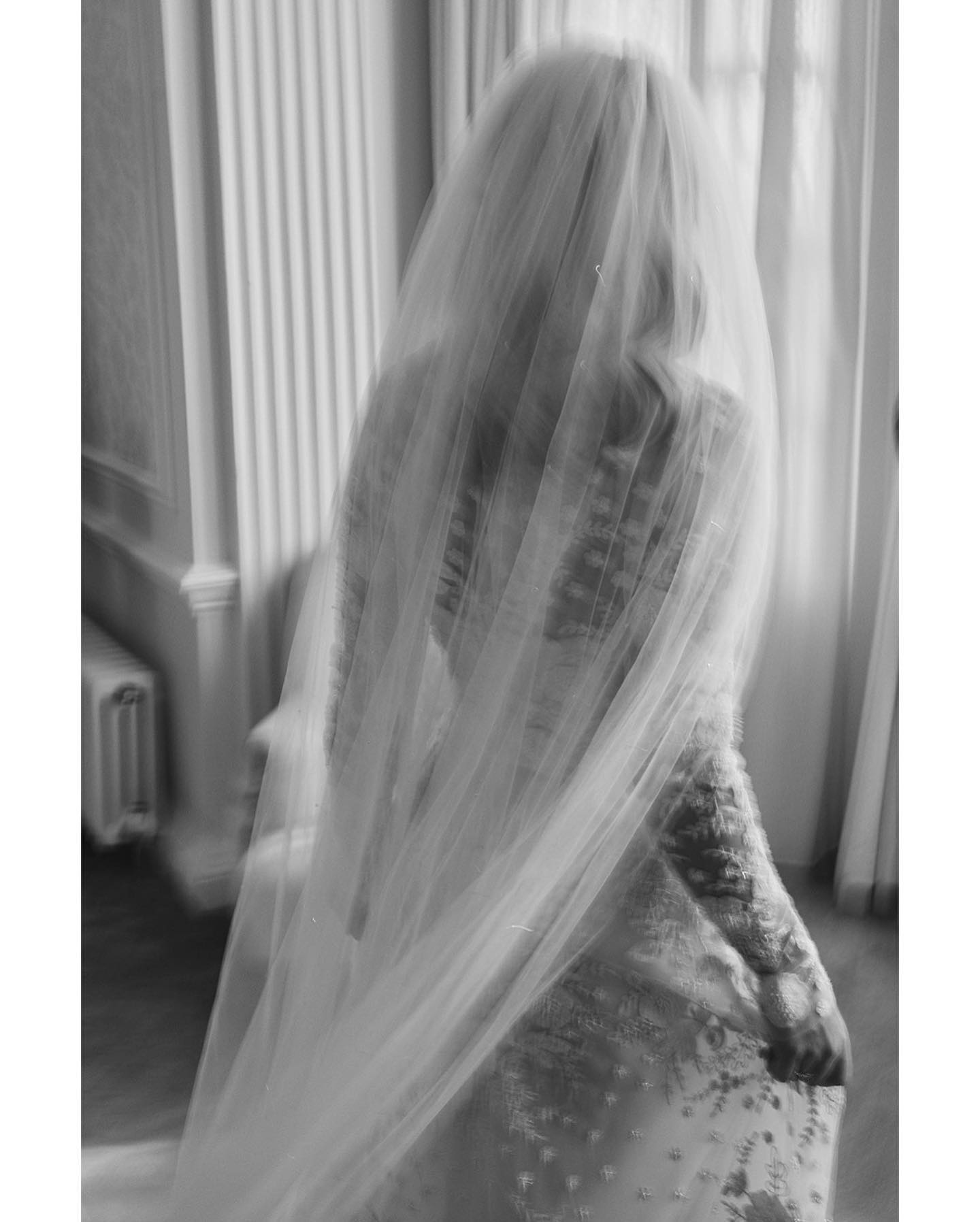 A black and white image in an editorial style of a bridal in her wedding veil at Hedsor House by Benjamin Wheeler.