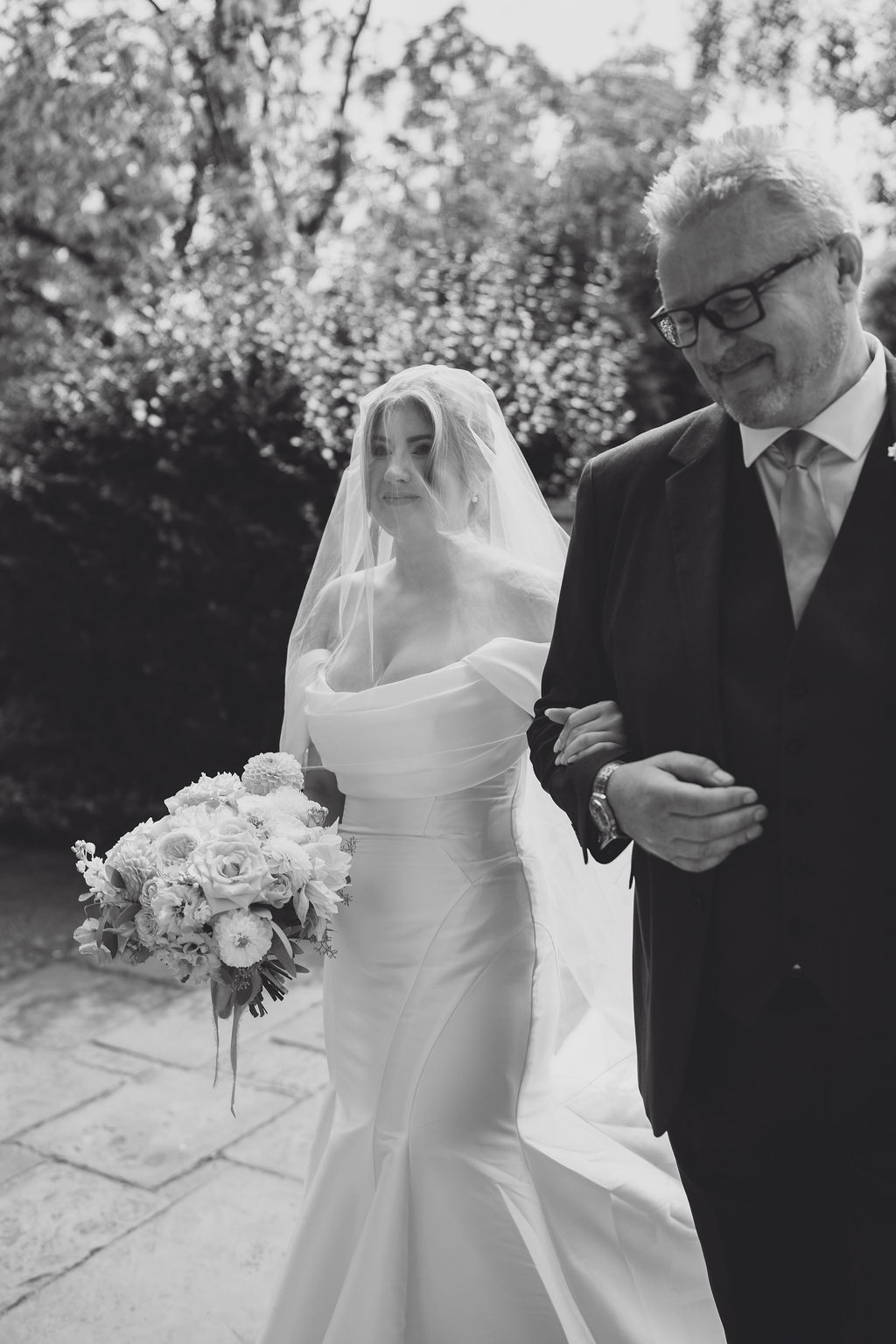 bride-and-father-at-natwich-church-wedding A black and white image of a bride and her father entering the doors of Nantwich church on a summer wedding day planned by Soiree studio.