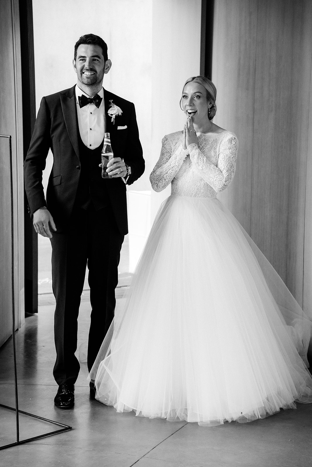 A black and white image of a couple entering their wedding venue at Dorfold Hall in Cheshire.
