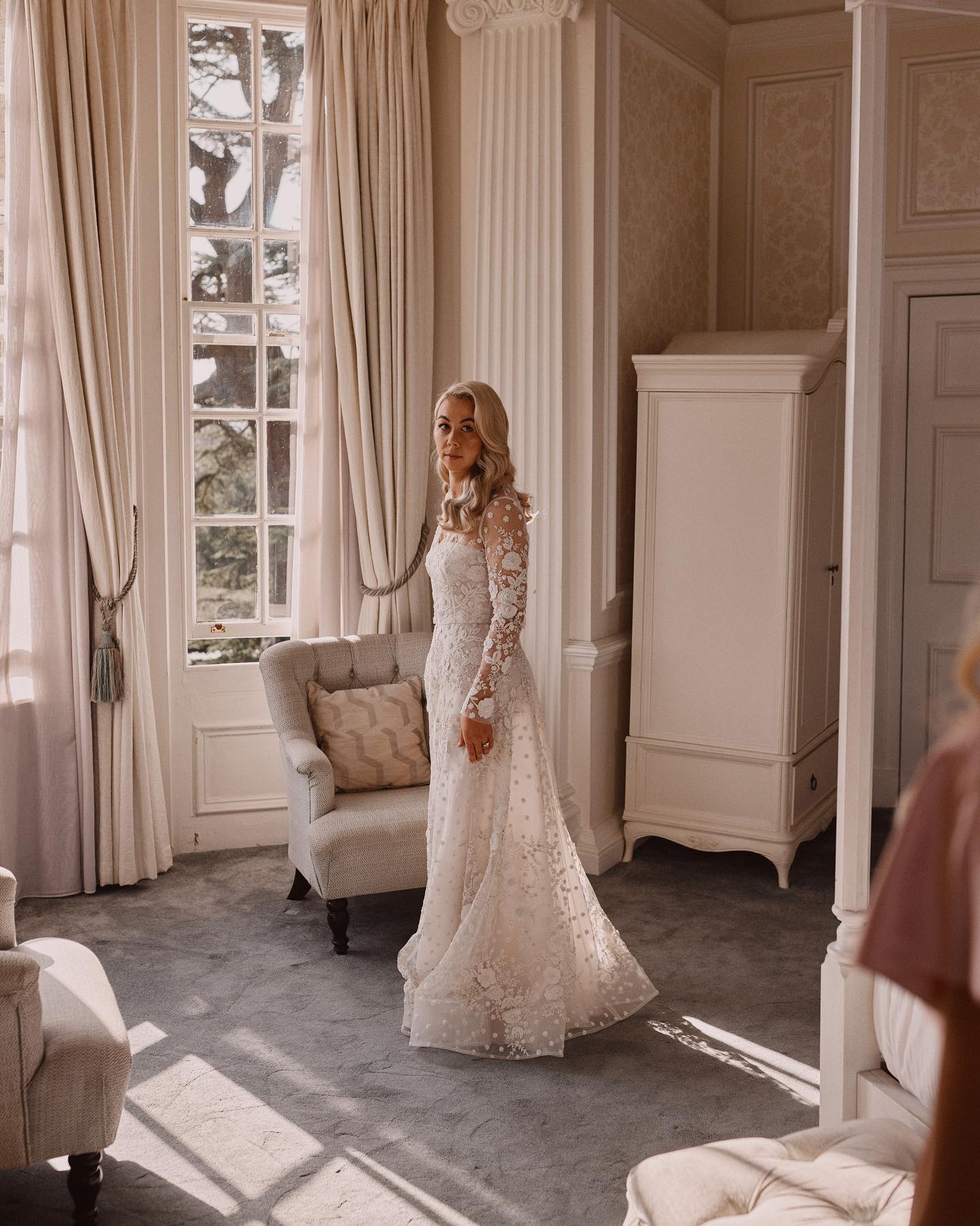 A colour image of a bride in a beautiful lace dress before her wedding ceremony at Hedsor House, shot by Benjamin Wheeler.