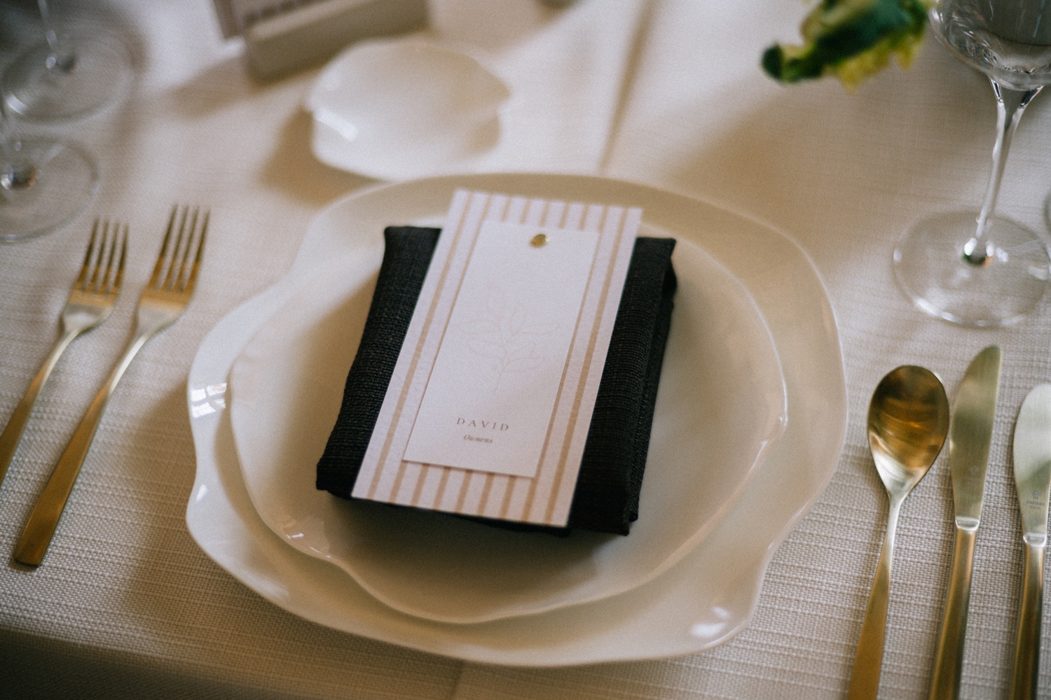 cheshire-wedding-planner-portfolio A colour image of a wedding place setting with mocha napkins on porcelain ripple plates by cheshire wedding planner.