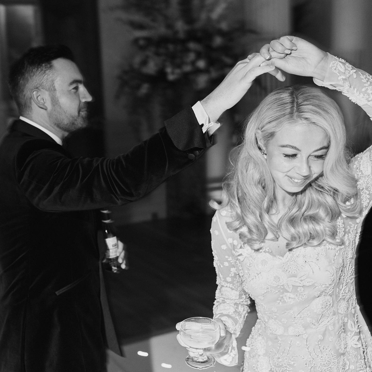 A black and white image of a groom twirling his bride around the dance floor at Hedsor House in Buckinghamshire.