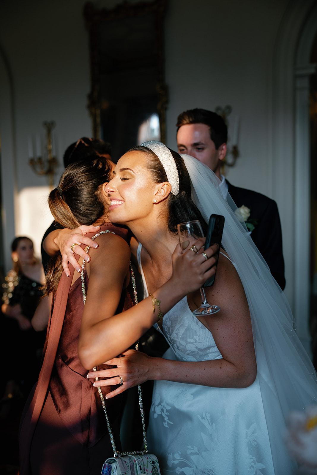 Madeleine & Chris A colour image of a bride embracing her friend after her wedding ceremony.