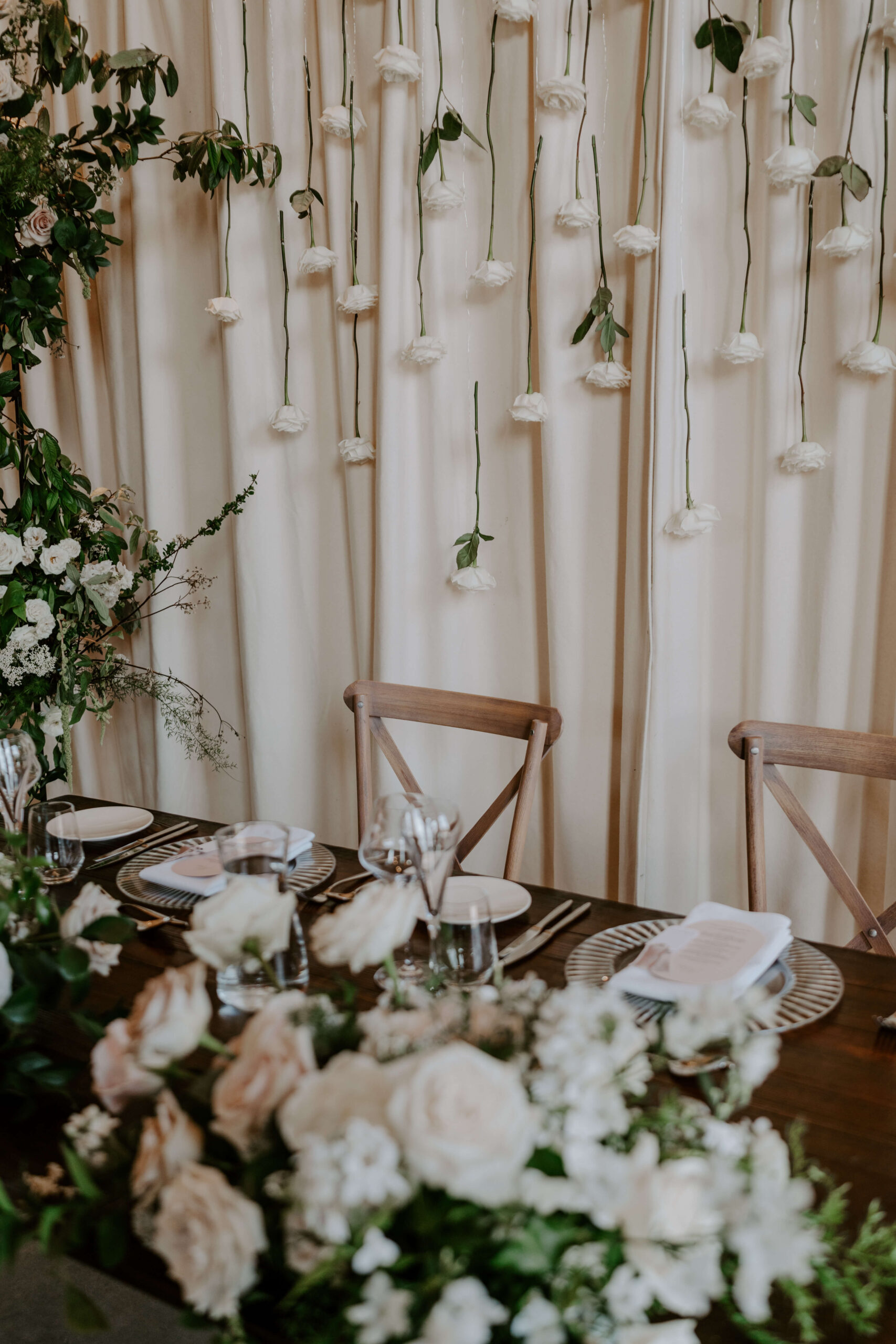 luxury-floristry-sassflower-cheshire-wedding-planning A colour image of a wedding top table adorned with fresh spring blush flowers and wedding table stationery designed by Soiree Studio Cheshire.