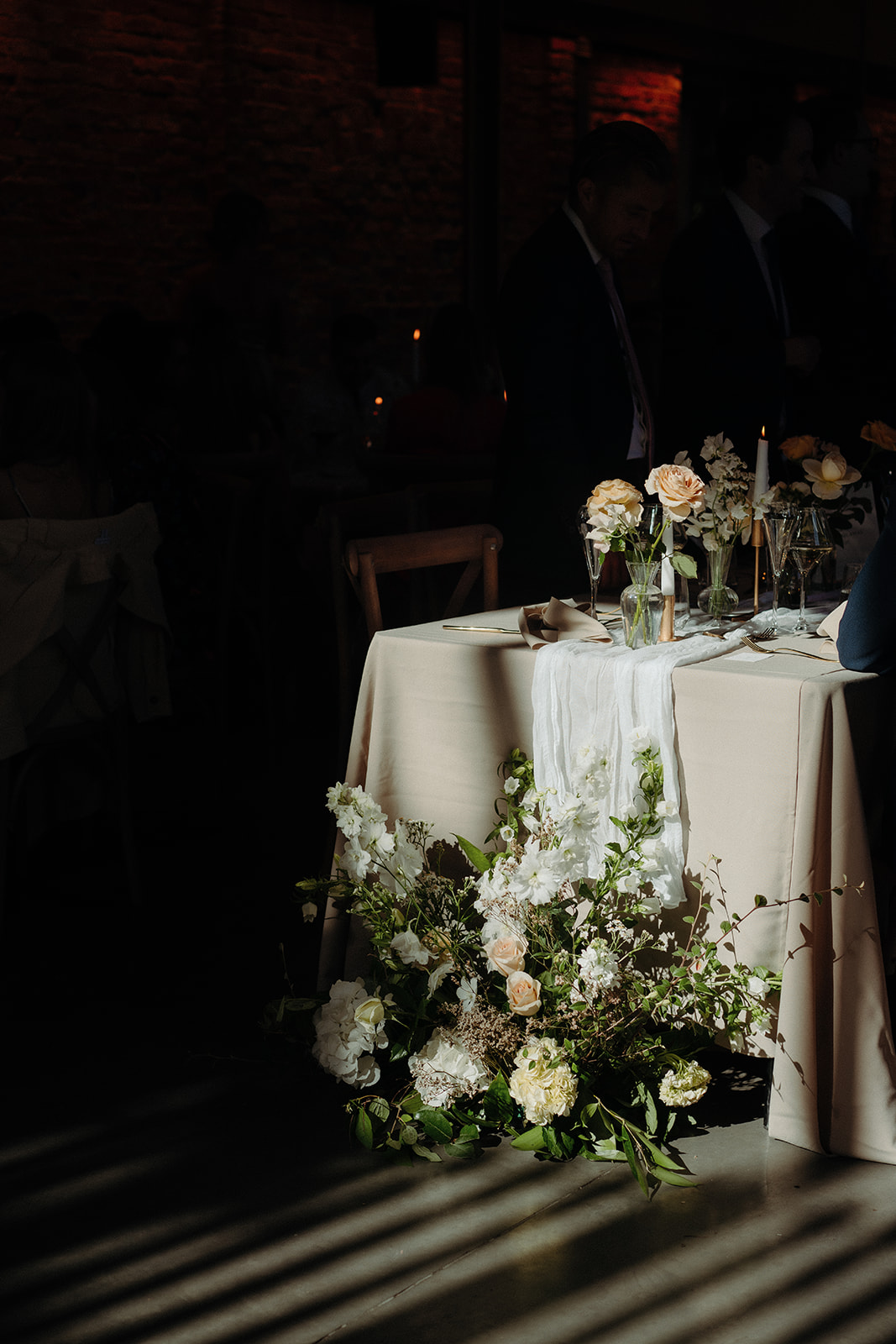 Amy and Jack A colour image of long wedding tables with neutral table linen and spring flowers planned at Dorfold Hall in Cheshire.