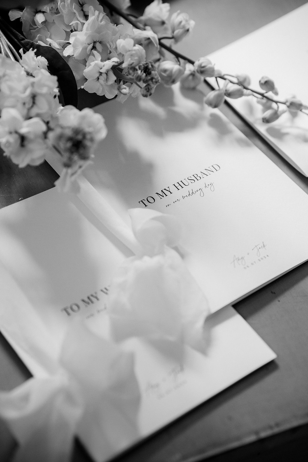 Amy and Jack A black and white image of the bride and grooms vow books produced by Soirée Studio in Cheshire.