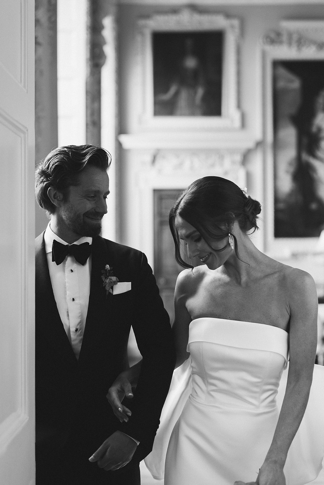 A black and white image of a bride and groom sharing a moment of laughter at Hawkstone Hall Shrewsbury.