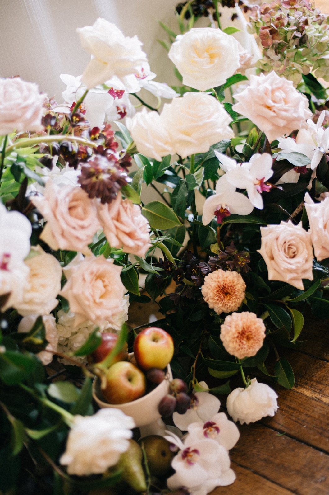 marquee-wedding-planner-near-cheshire A colour image of autumn floral arrangements in blush and mocha with decorative apples for a marquee wedding in Cheshire.