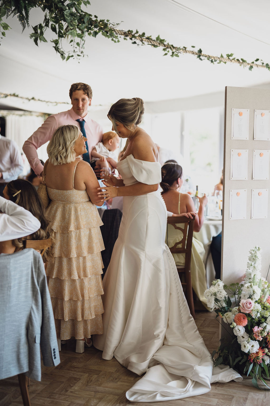 private-estate-marquee-wedding-in-shropshire A bride talking to her guests at her marquee wedding in Shropshire.