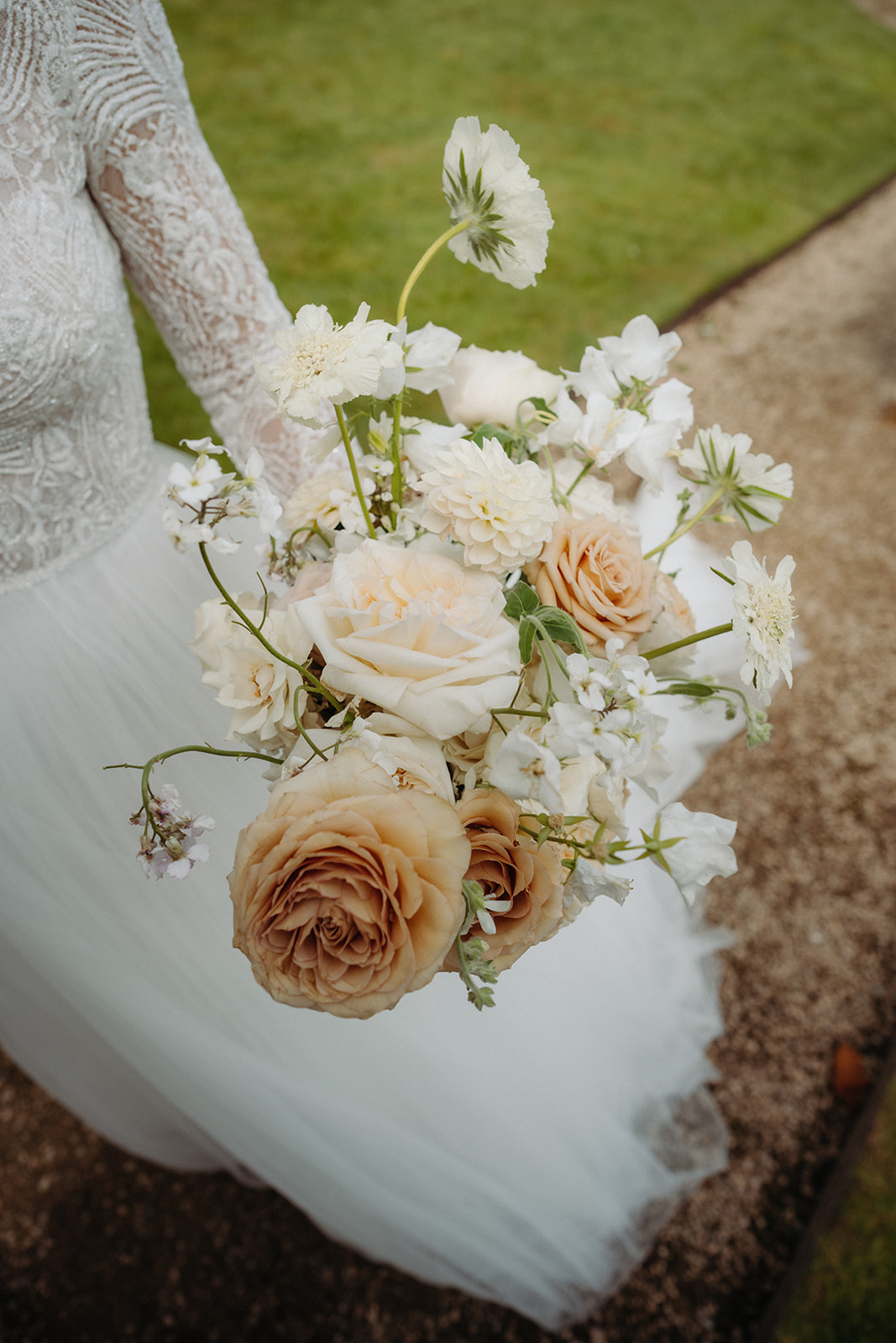 Amy and Jack A colour image of a print floral bouquet with peach tones by Sassflower wedding florist Cheshire.