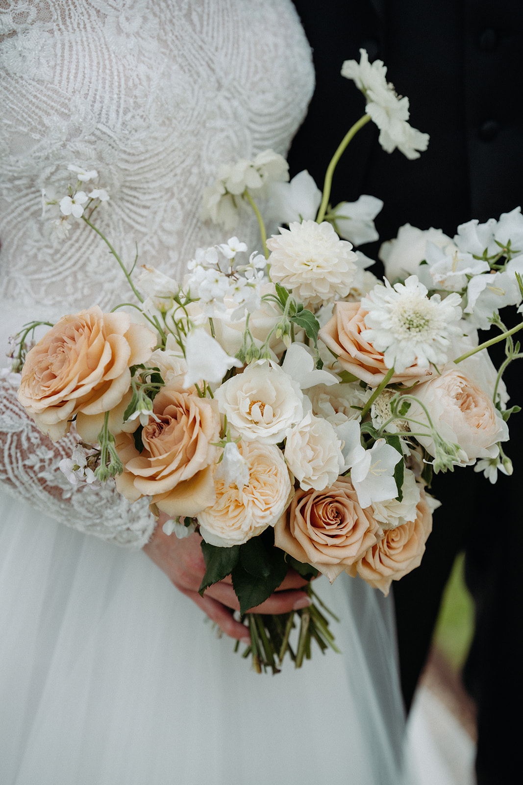 Amy and Jack A colour image of a spring peach floral wedding bouquet by Sassflower Cheshire florist.