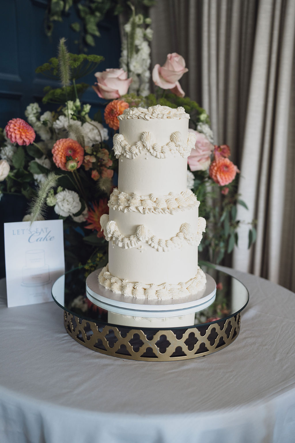 traditional-style-wedding-cake-lambeth-marquee-wedding-shropshire A colour image of a traditional style lambeth cake at a summer marquee wedding with fresh summer flowers in pink and peach in the background, planned by soiree studio in Shropshire.