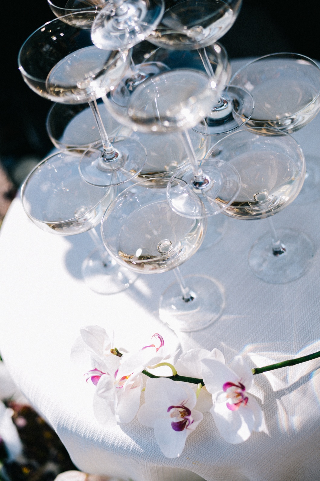 wedding-champagne-tower-cotswolds-wedding-planner A colour image of a wedding champagne tower with soft pink flowers at a cotswold marquee wedding.