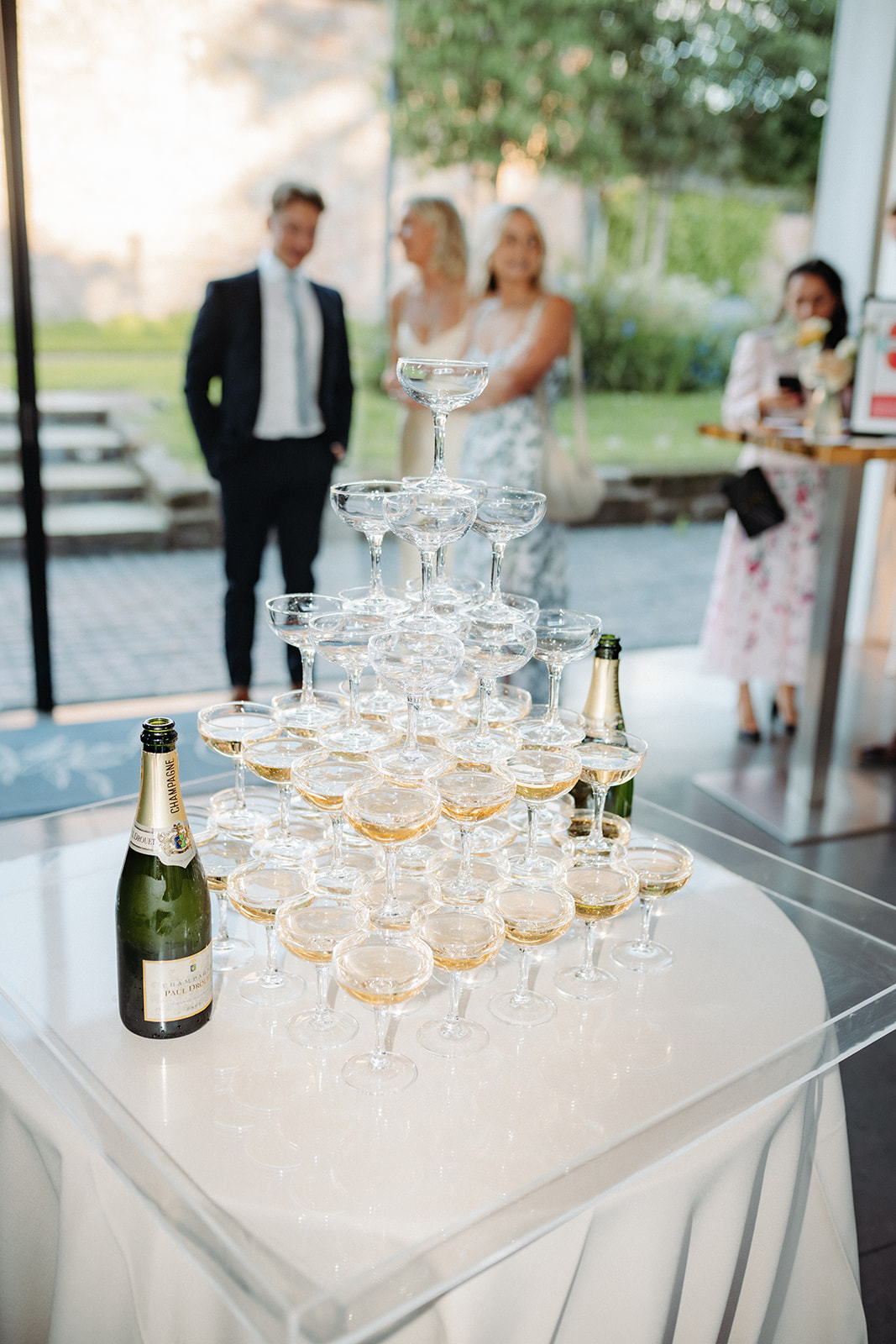 Amy and Jack A colour image of a champagne tower at a wedding reception planned at Dorfold Hall with Soiree Studio.