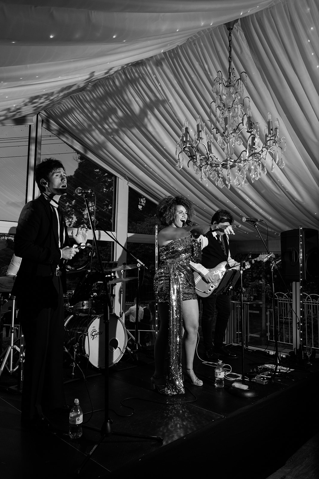 A black and white image of the Mint Band performing at a marquee wedding in Cheshire planned by Soirée Studio.