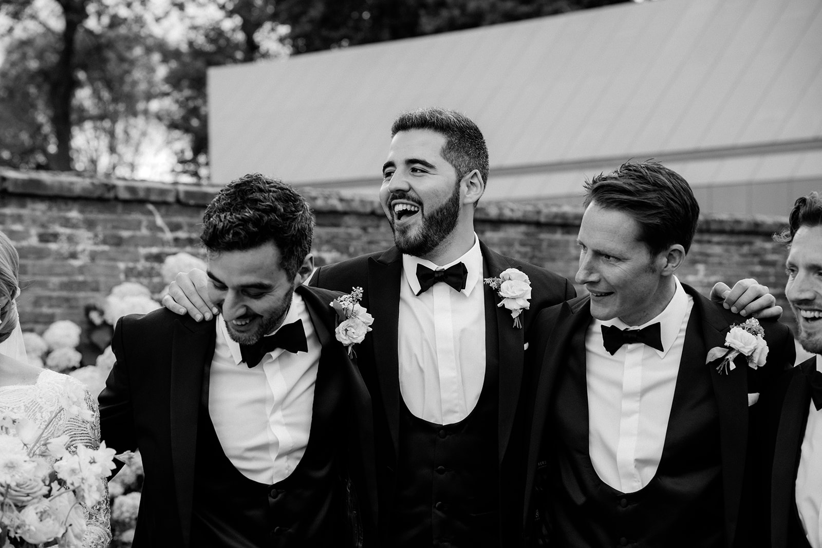 Amy and Jack A black and white image of a bridal party with all men in tuxedos looking very dapper and smart at Dorfold Hall in Cheshire.
