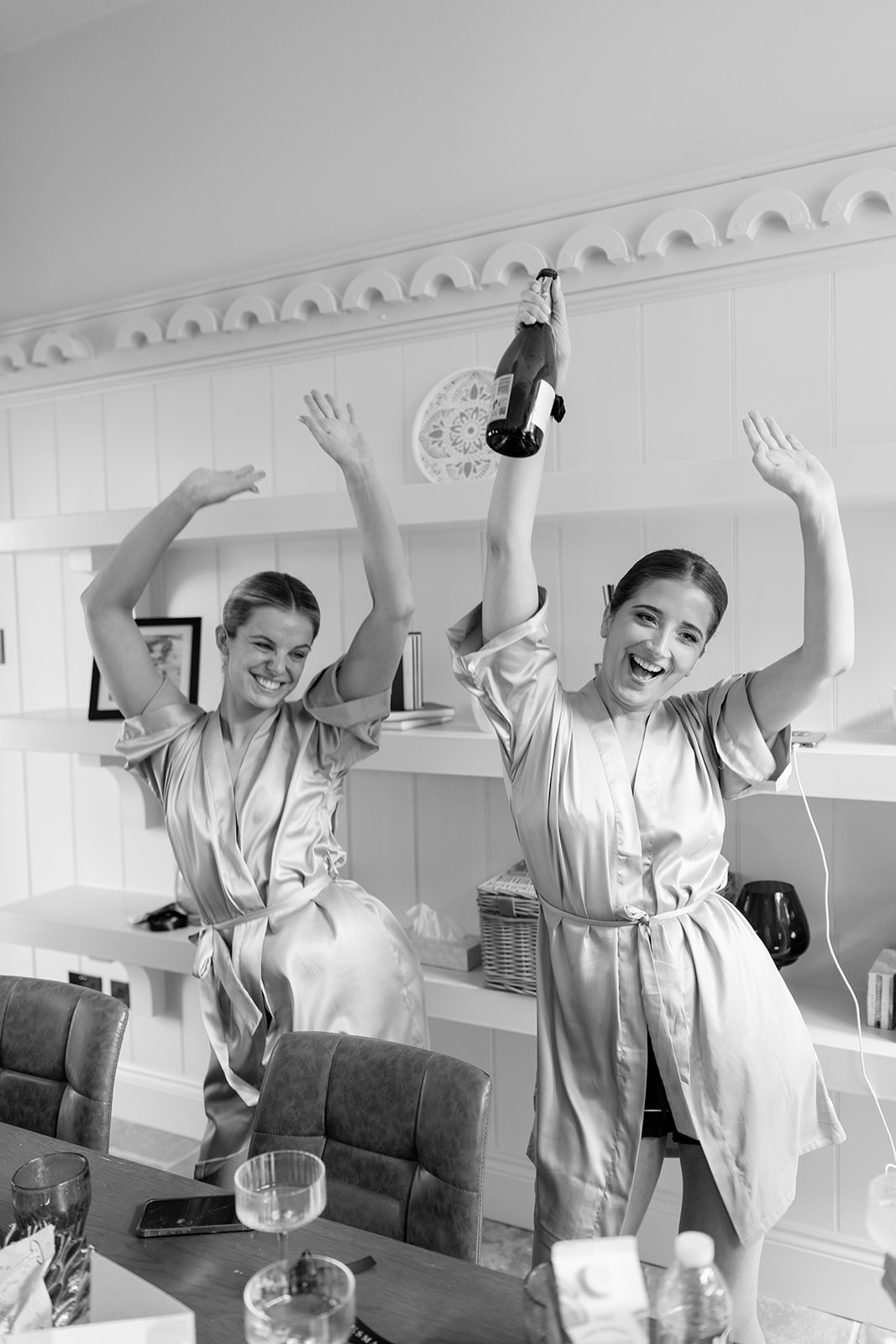 Madeleine & Chris A black and white image of bridesmaids getting ready at Capesthorne Hall Cheshire.