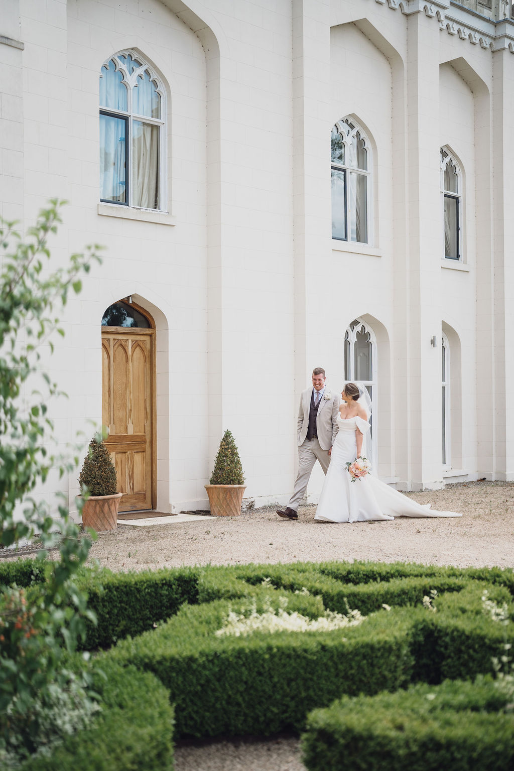 wedding-photography-wedding-planner-combermere-abbey-shropshire A colour image of a couple having their portraits taken outside Combermere Abbey after their wedding ceremony in Shropshire.