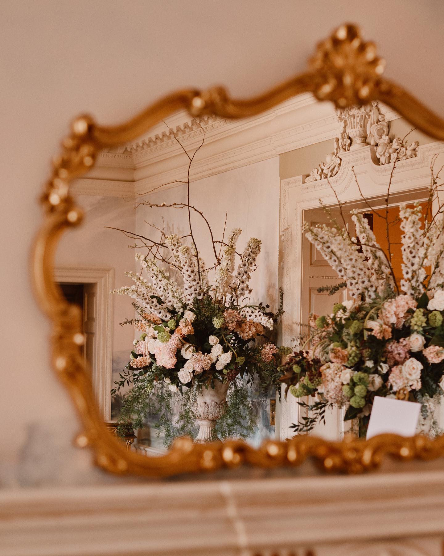 A colour image of an orange gold mirror at Hedsor House in Buckinghamshire.