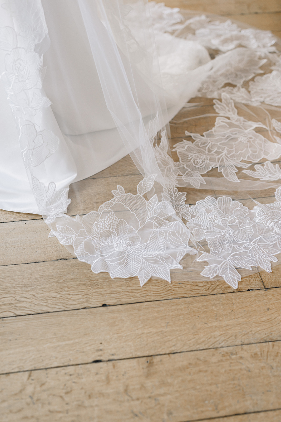 A colour image of a beautiful intricate wedding veil adorned with flowers at a boutique in Shropshire.