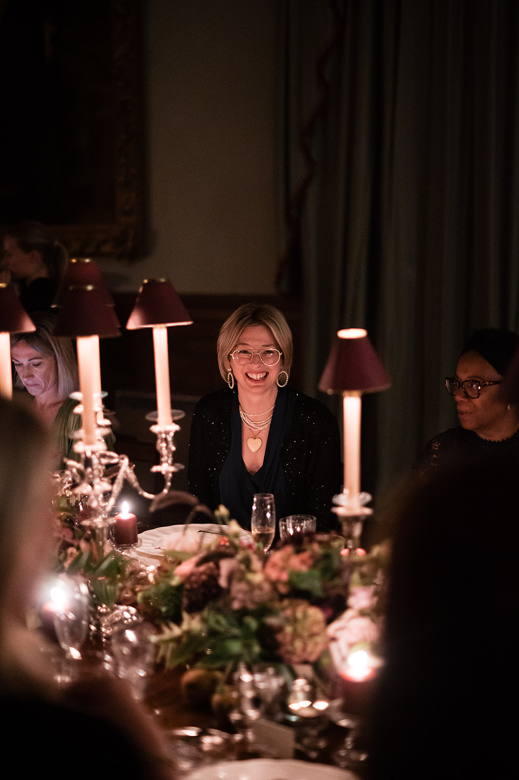 A bride and groom walking through the hallway at Birdsall House in Yorkshire after their wedding ceremony.