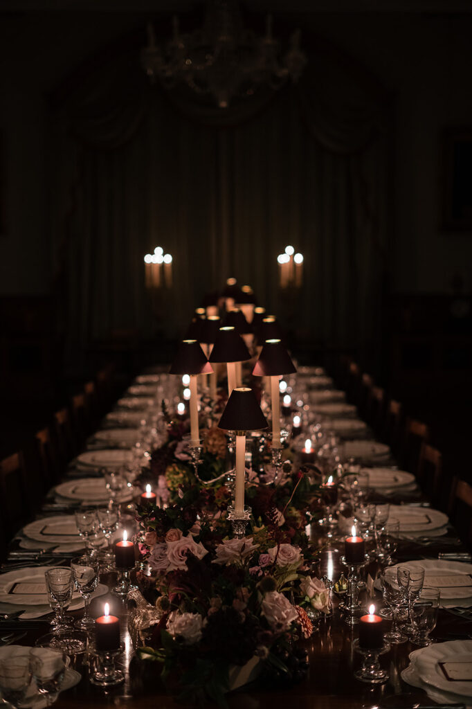 A colour image of the dining table at Birdsall House, UK wedding venue, styled for an evening rehearsal dinner with lots of candles.