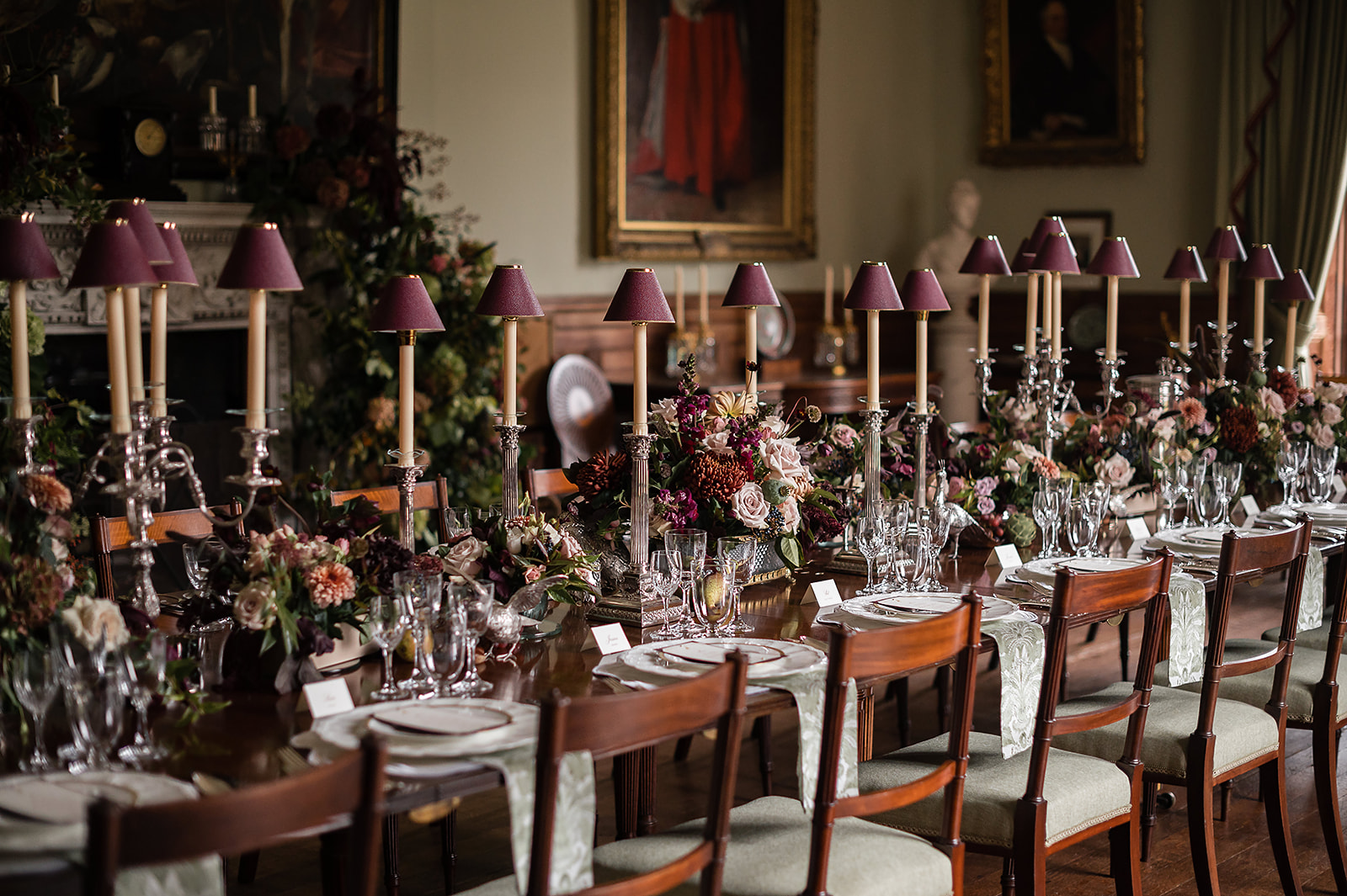 A black and white image of a bride and groom walking down the stairs at Birdsall House in Yorkshire.