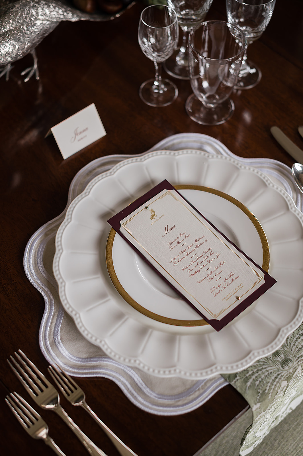 A colour image of an autumnal wedding table setting planned by UK wedding planner Soiree Studio.
