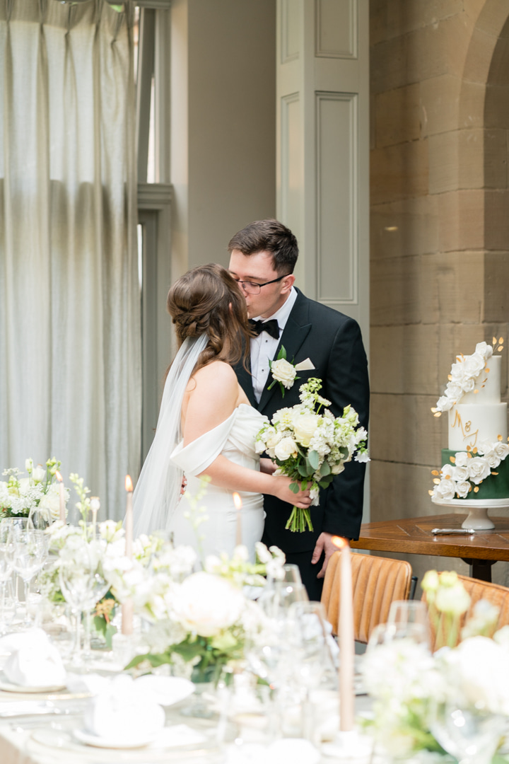 A black and white image of a bride and her father entering the doors of Nantwich church on a summer wedding day planned by Soiree studio.