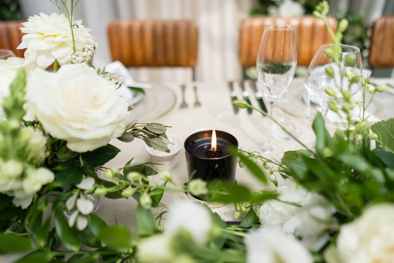 A colour image of a bride with her bridesmaids wearing butter yellow bridesmaid dresses with beautiful summer floral bouquets in pink and peach at a marquee wedding in Shropshire.