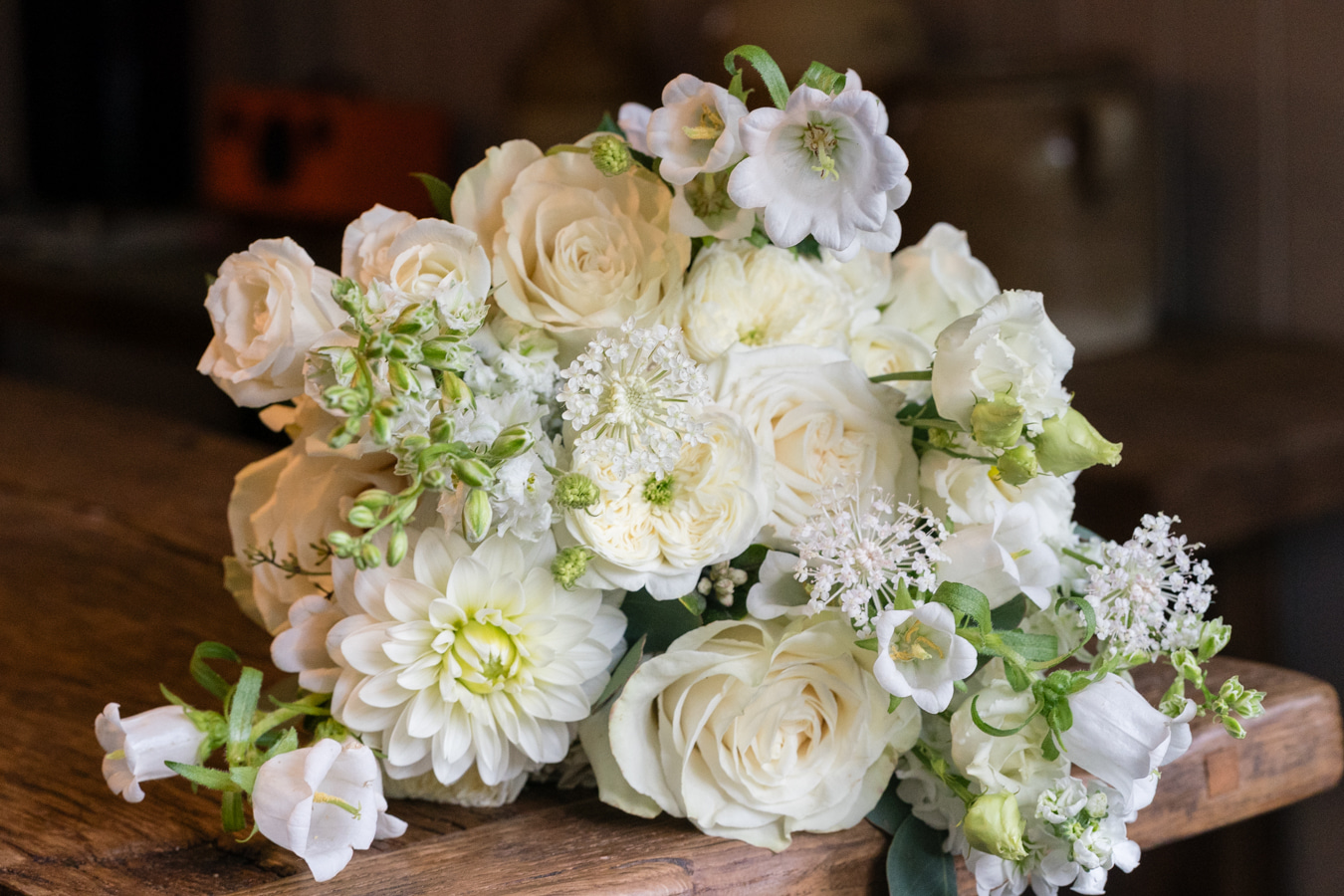 A colour image of a spring wedding bouquet with white and fresh green flowers for a wedding at Hampton Manor wedding venue UK.